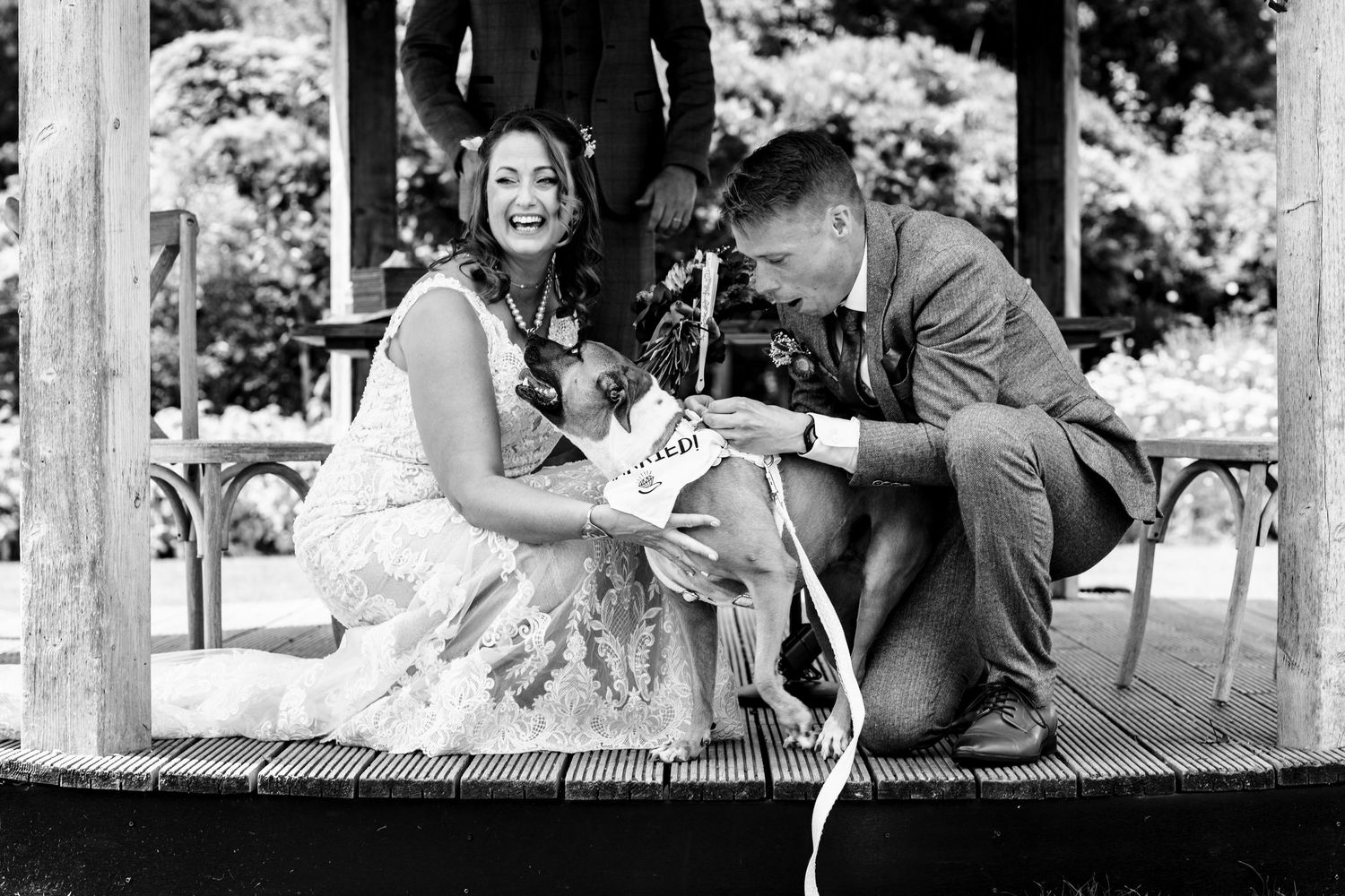 A series of black and white photos showing a couple in romantic poses outdoors during a wedding photo session.