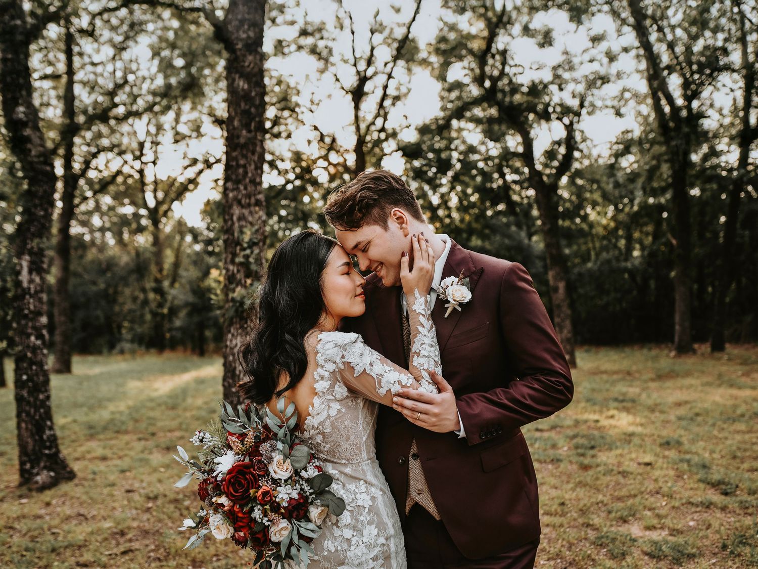 Bride and groom kissing in the woods at golden hour in Lake Dallas
