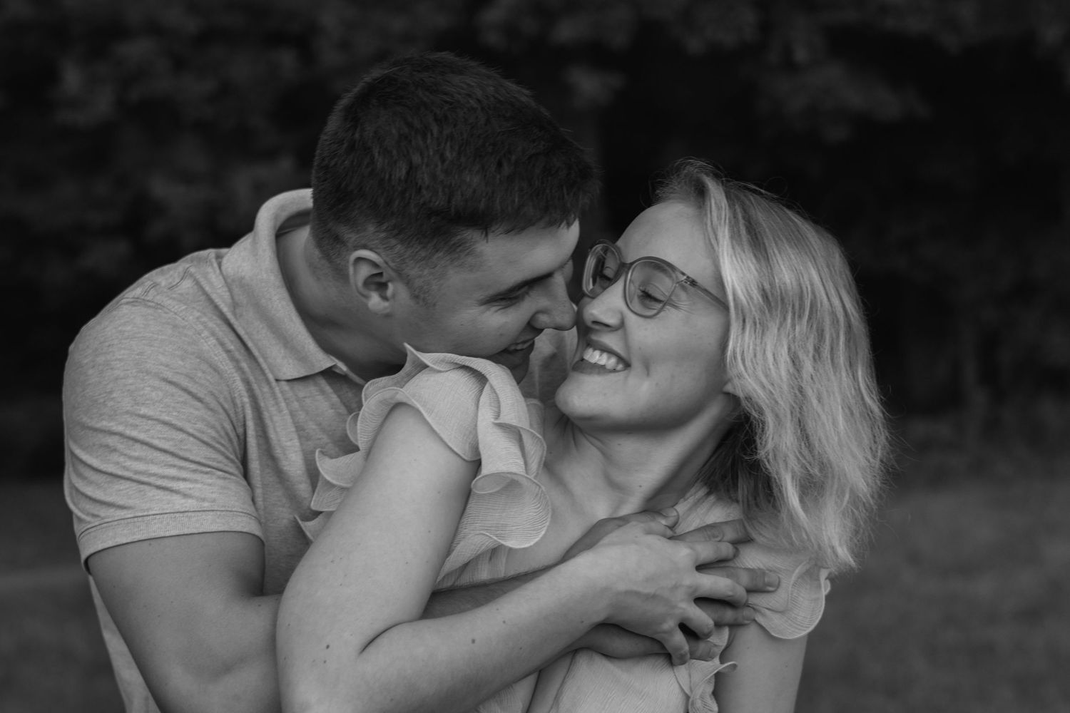 A romantic couple shares tender moments in a black and white photo series.
