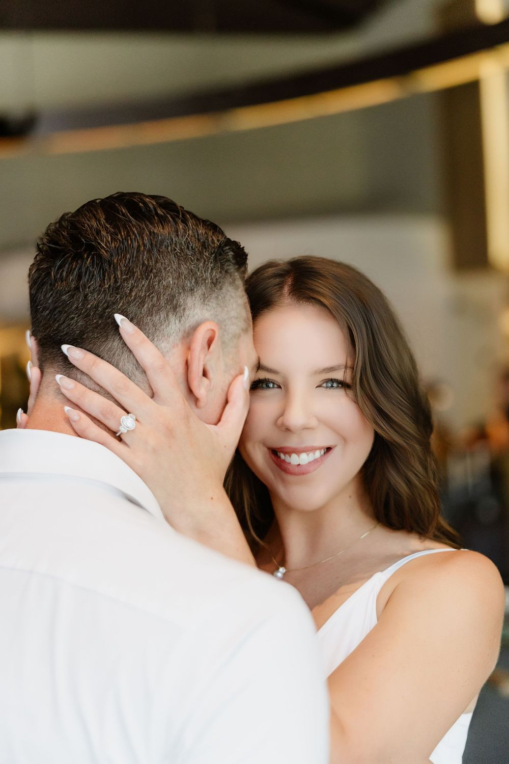 A romantic close-up moment between a couple sharing an intimate pose indoors.
