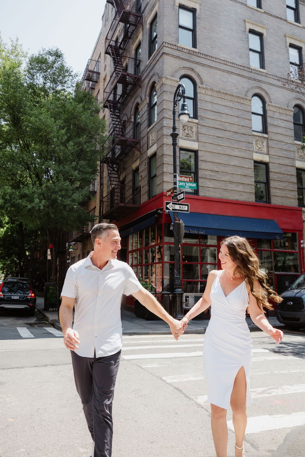 Playful street scene in an urban neighborhood with classic brick buildings and fire escapes.