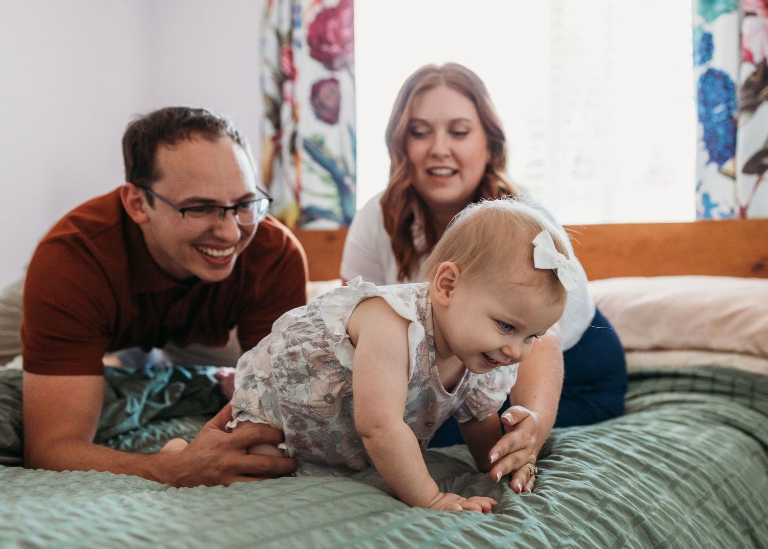 A sequence of candid family moments shows gentle interactions and laughter while playing together on a mint green bedspread.