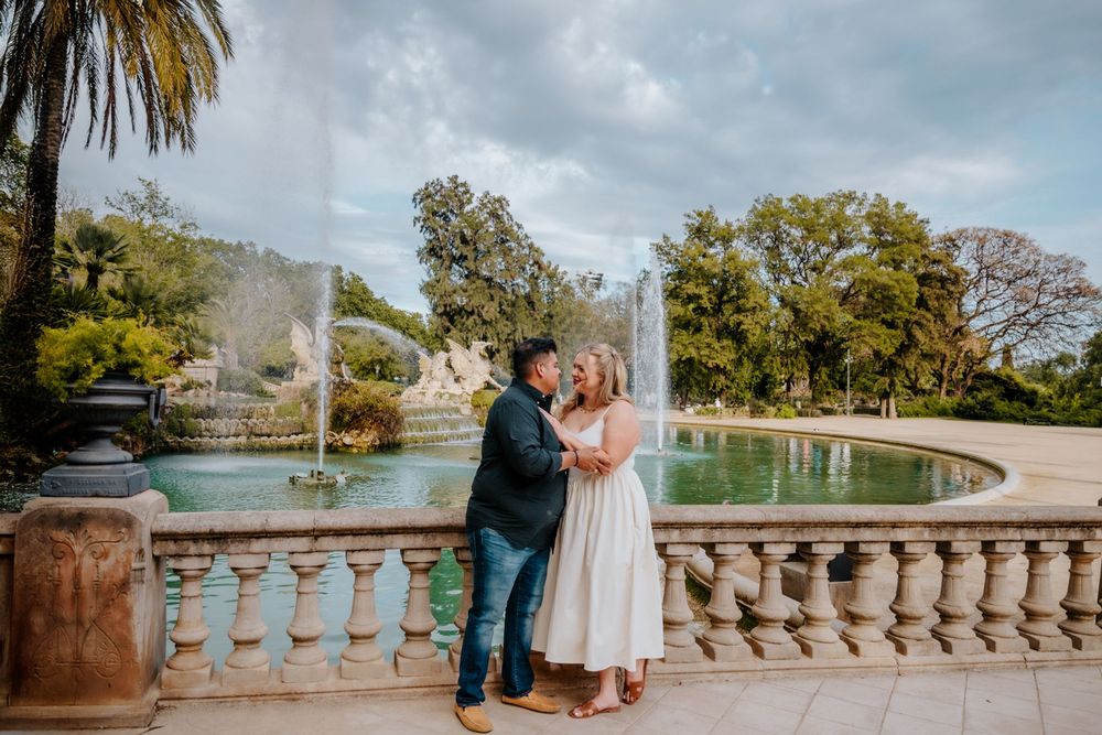 Couple walking hand in hand after the proposal in Barcelona.