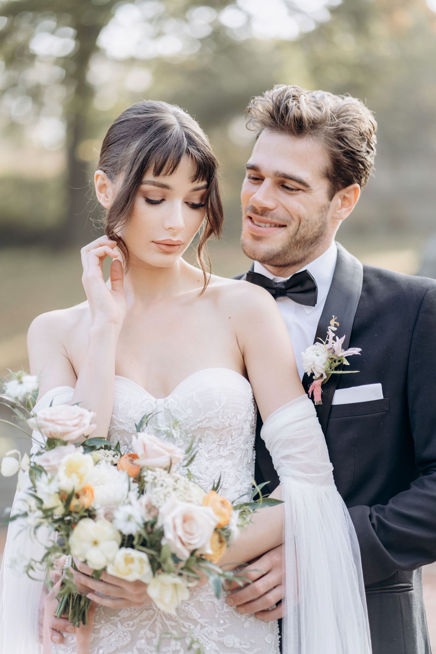 Romantic wedding portraits featuring a flowing white gown and elegant floral bouquet.