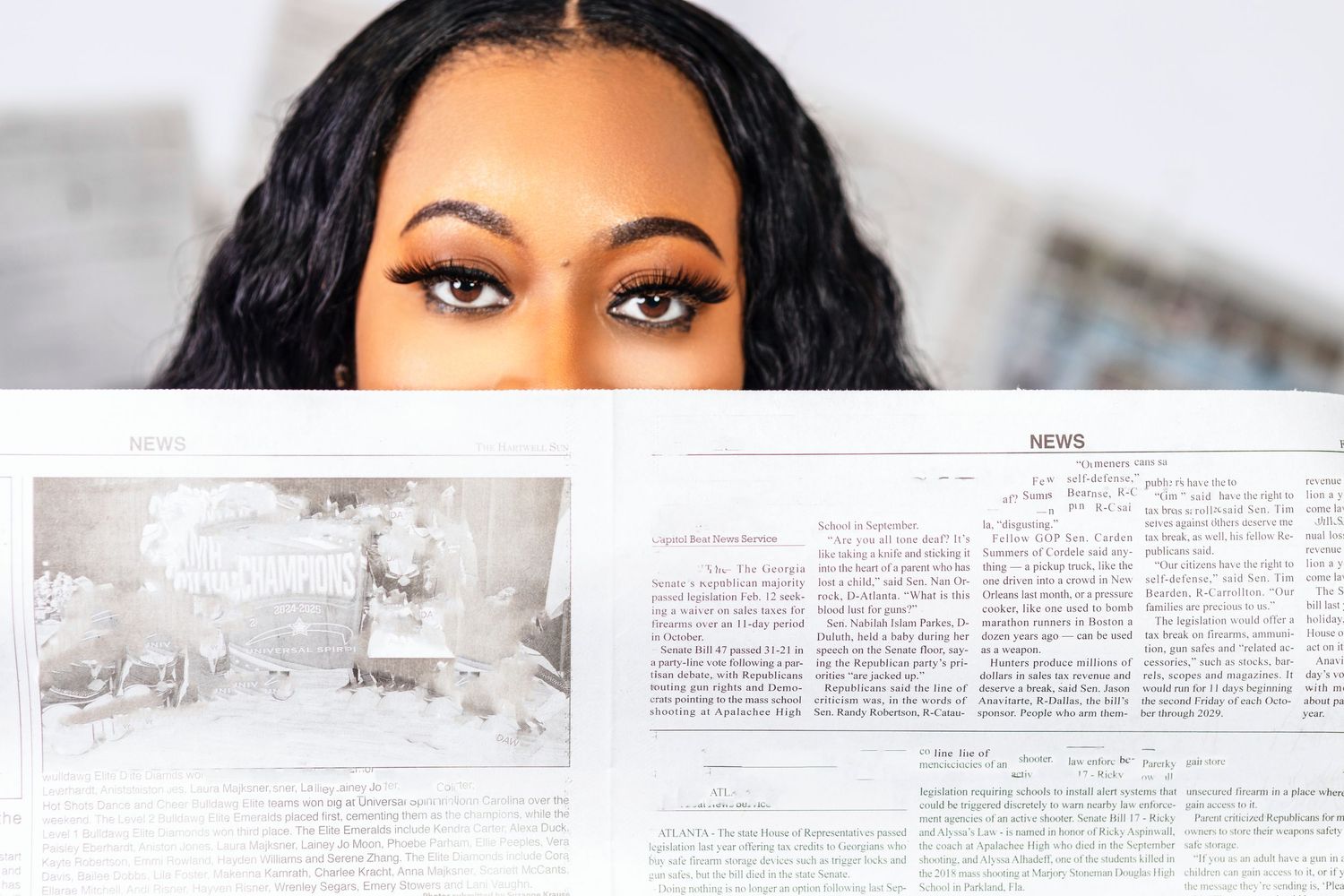 Close-up portrait with soft lighting and text documents in background.