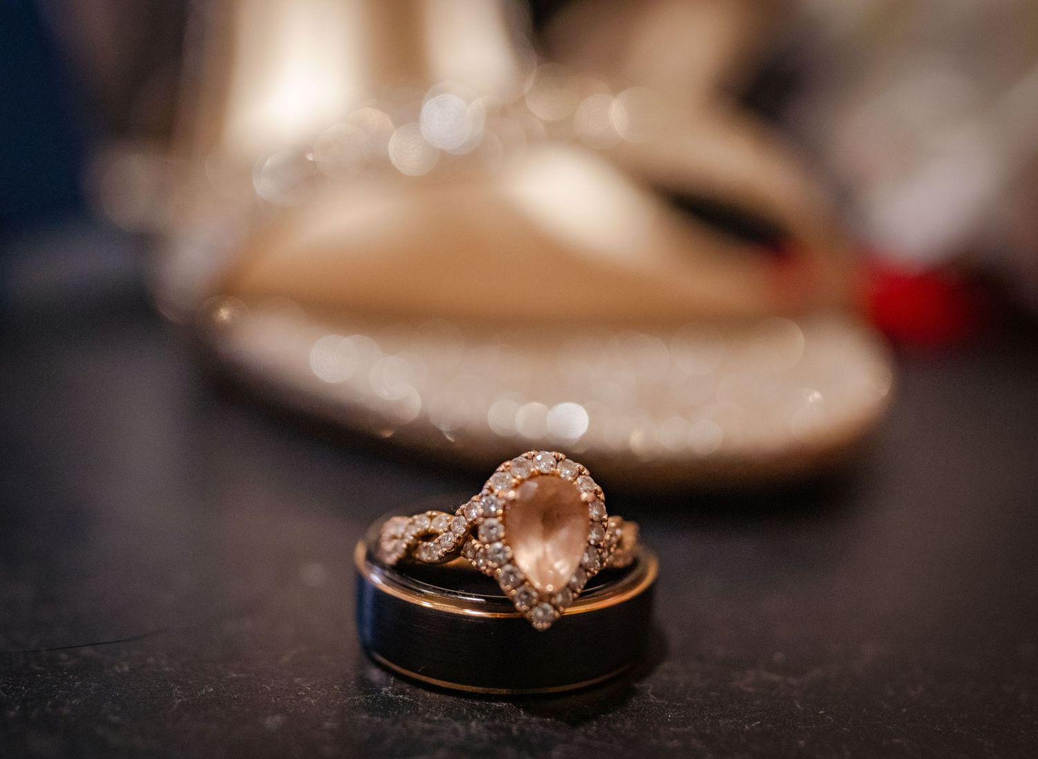 Close-up shots of diamond engagement rings on dark surfaces.