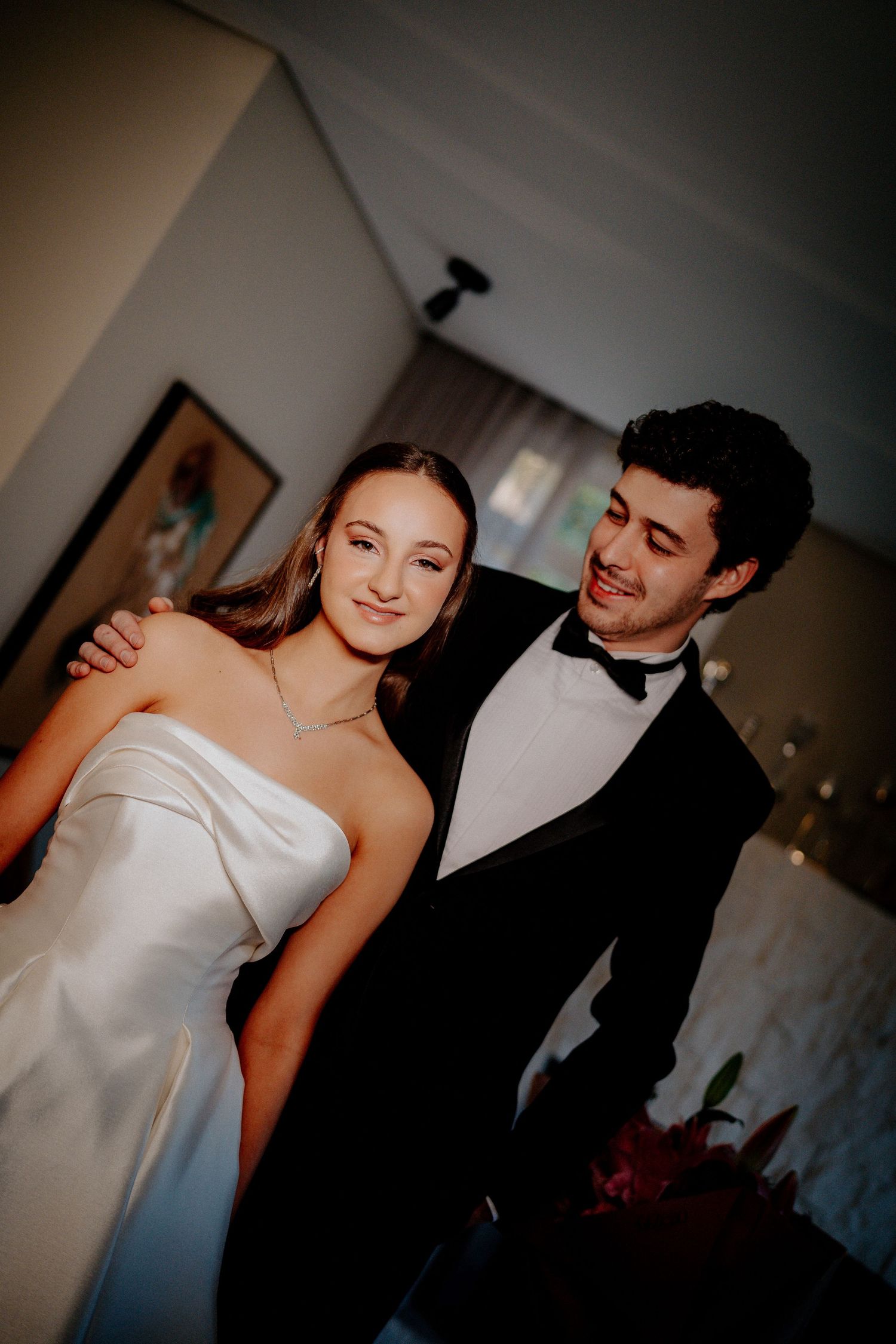 Romantic dance moment between couple at wedding with intimate lighting and formal attire.