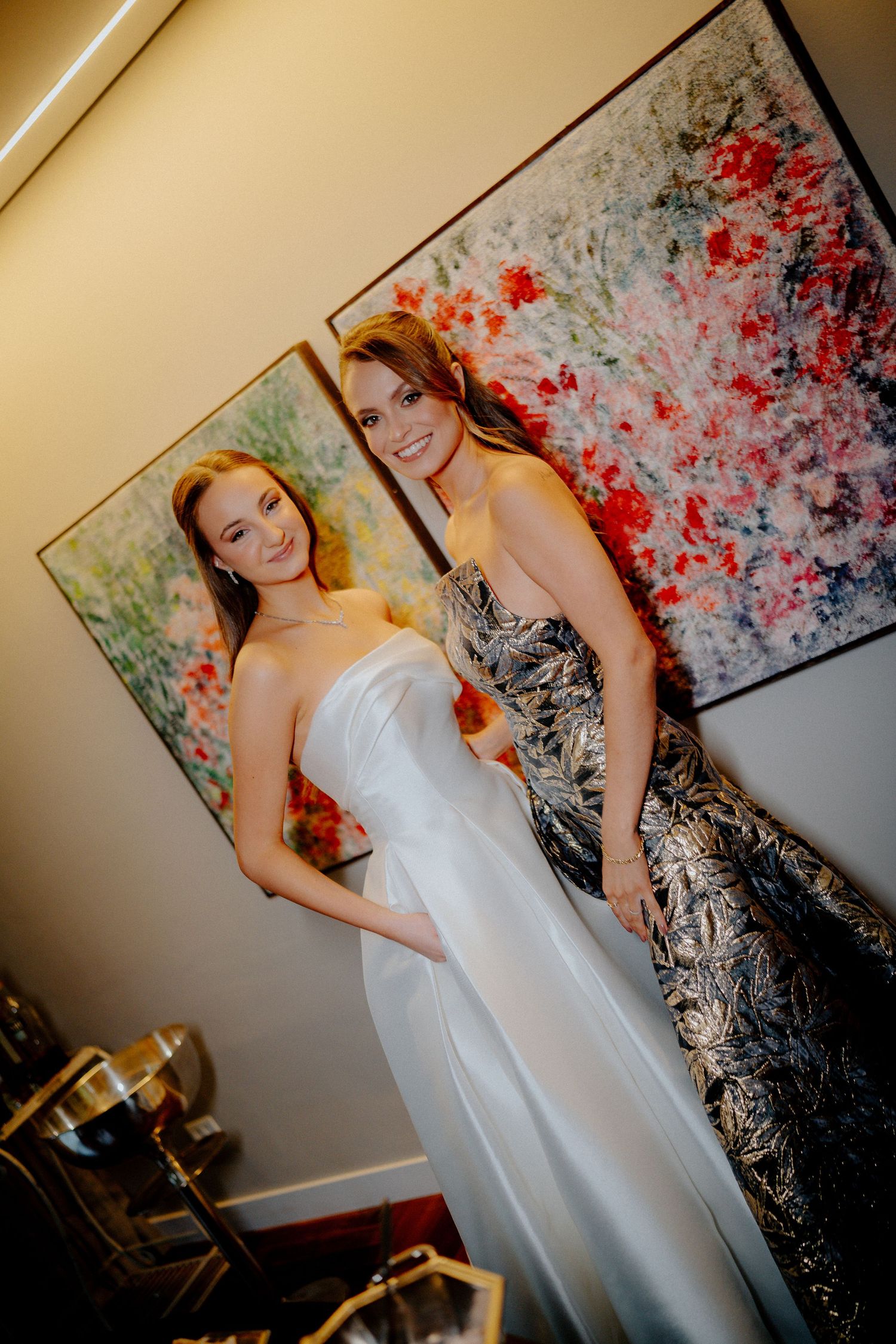 Wedding preparation shot with colorful abstract art background and white formal dress.