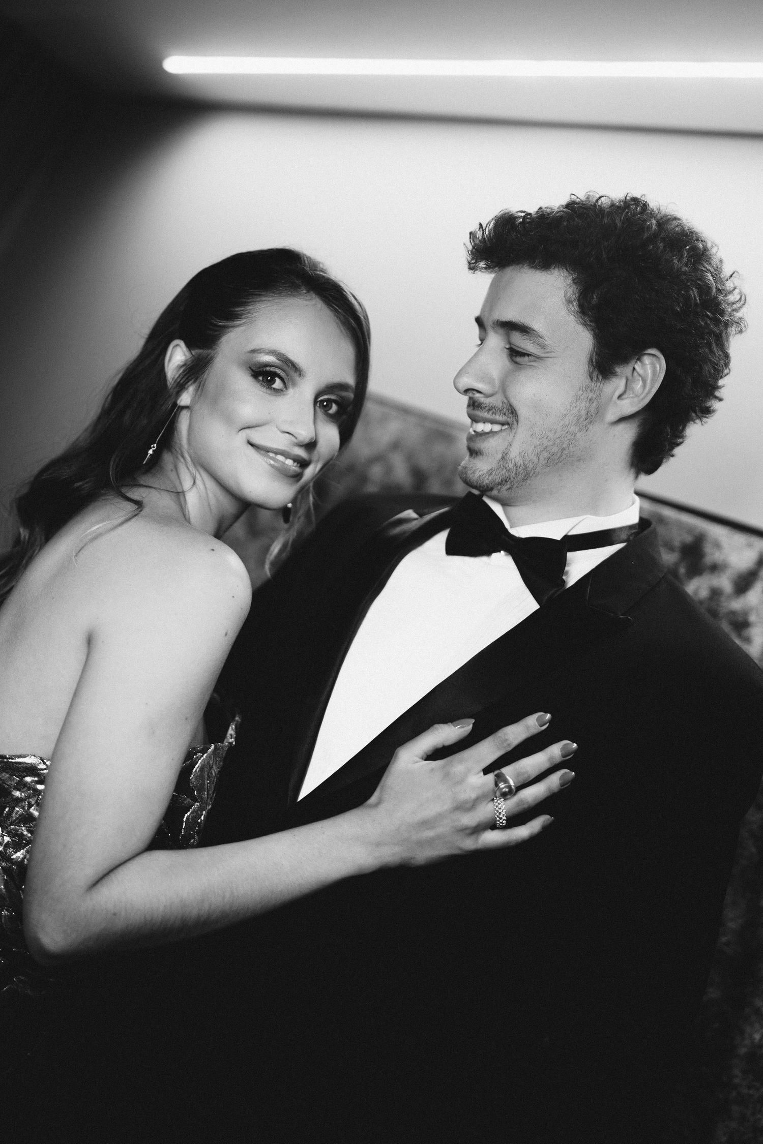 Romantic black and white portraits of a couple in formal wedding attire.
