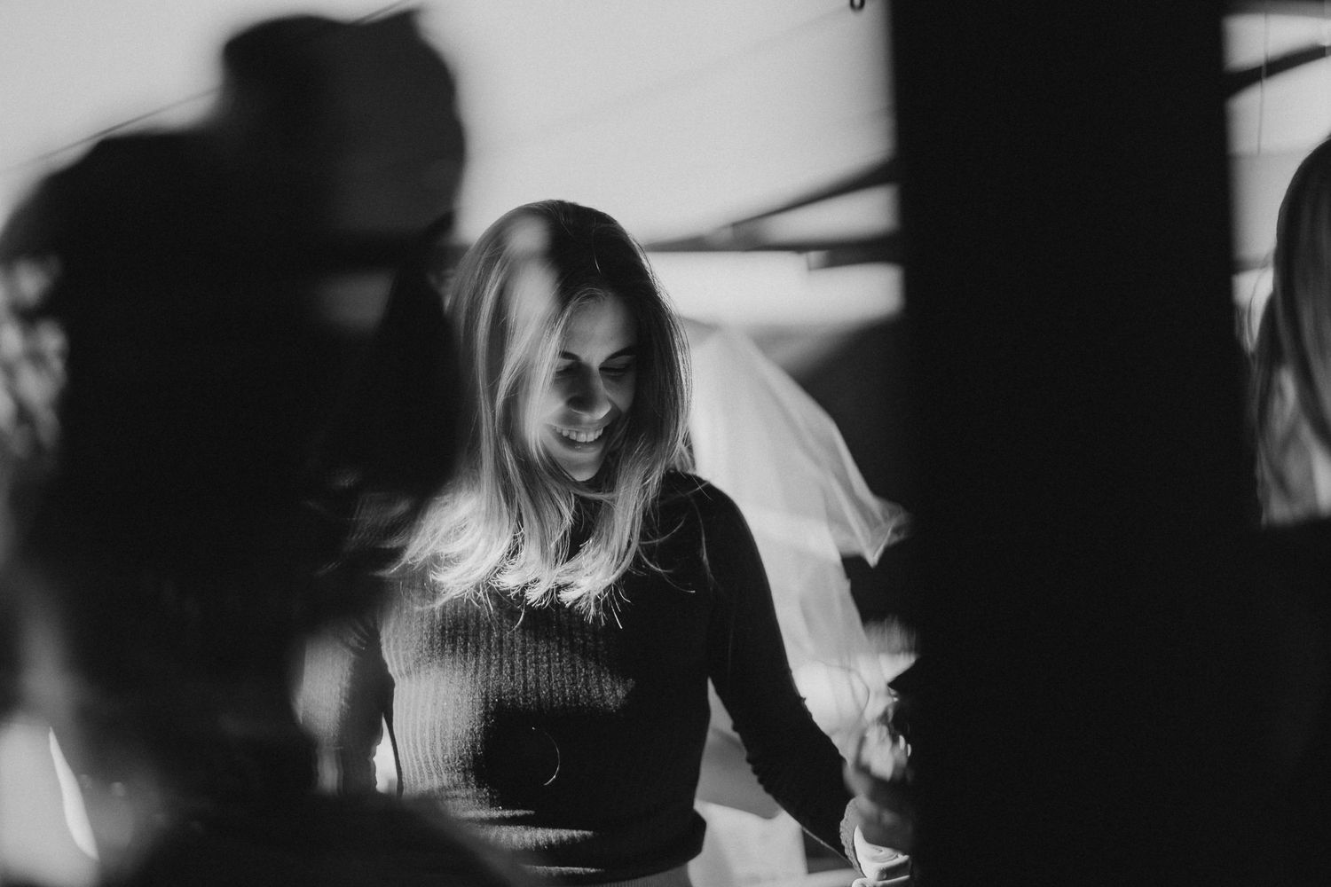 Dark atmospheric photo capturing silhouettes of people at celebration event.