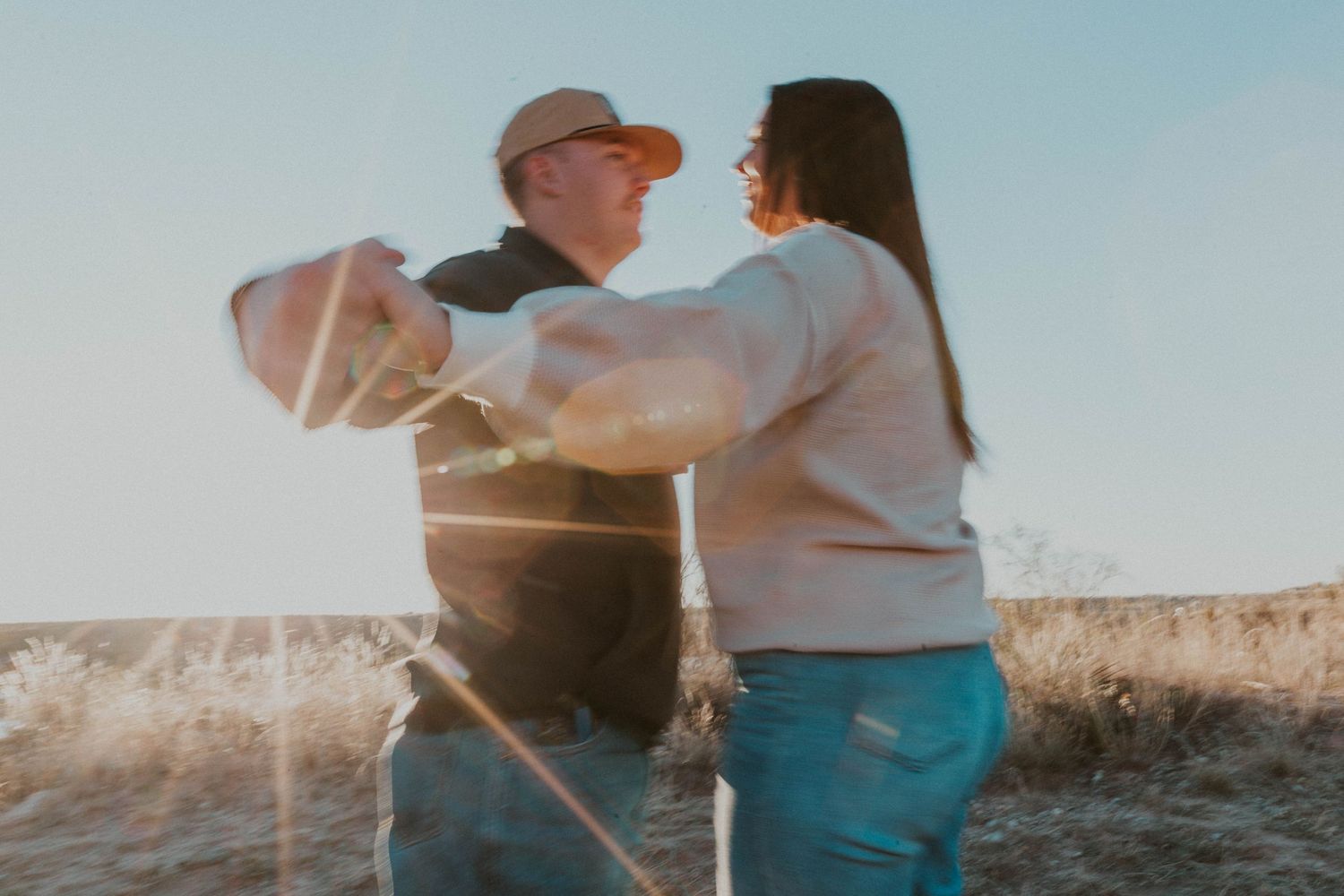 Young couple dances in the sunset.