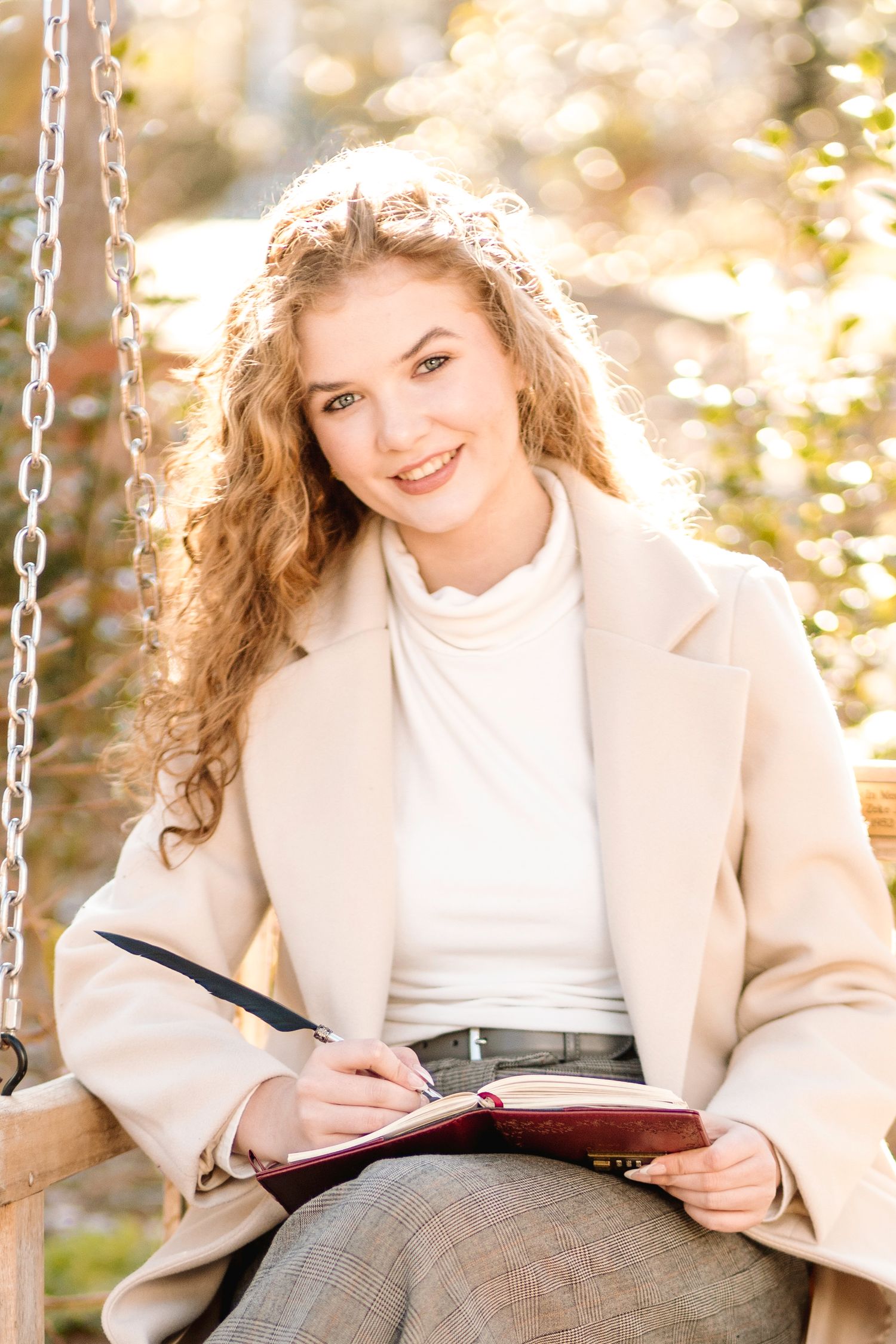 Three images of someone in a beige coat reading from a red book while sitting on a chain swing outdoors.