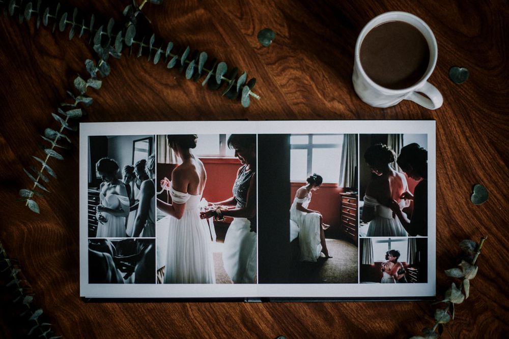 Collection of artistic polaroid photos arranged on a dark wooden surface with decorative elements.