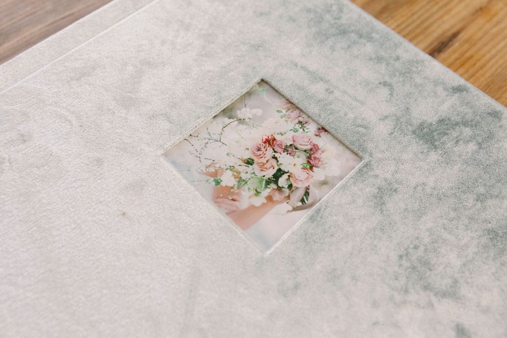 White paper gift boxes displayed on a textured gray marble or concrete surface.