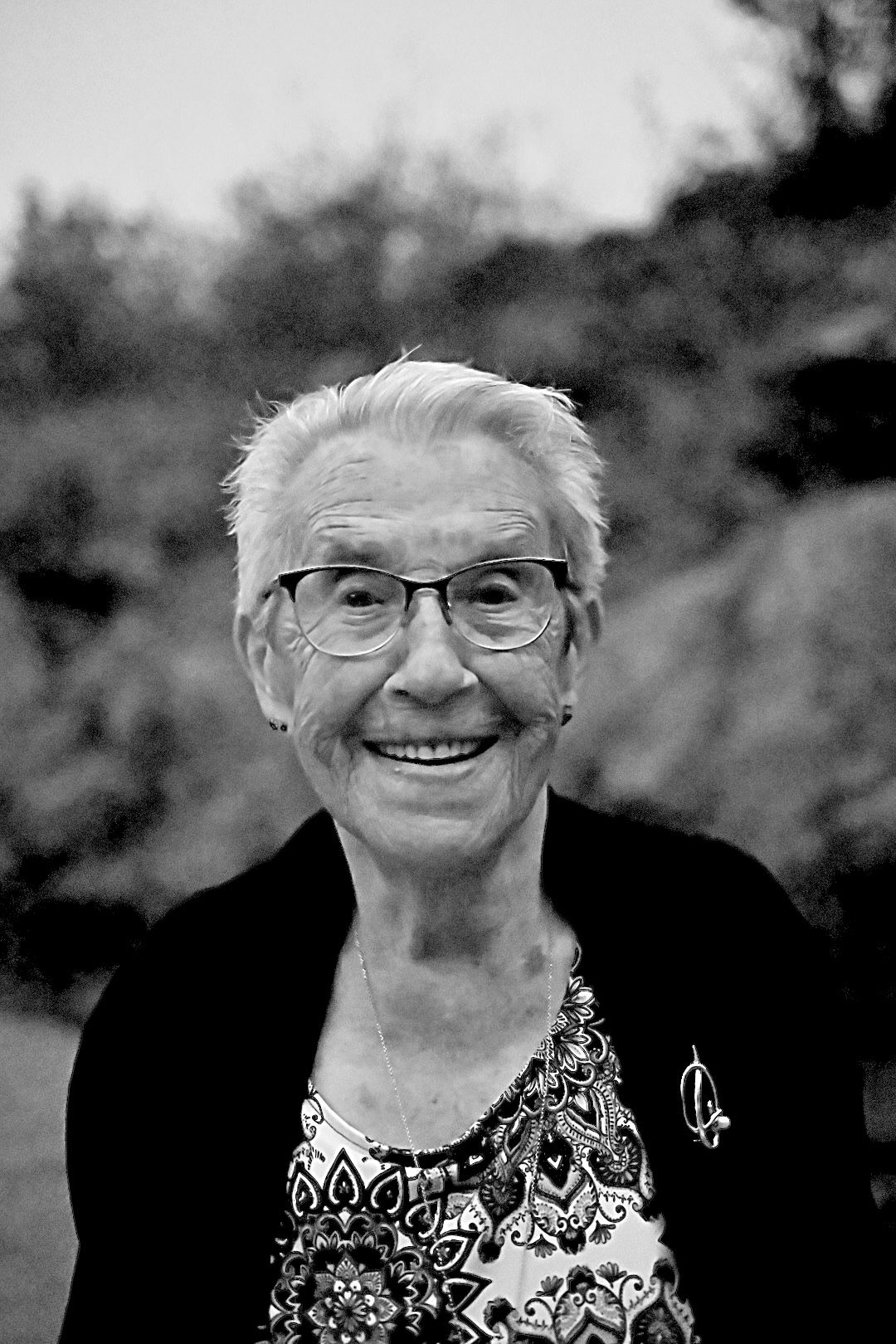 Old lady photographed at a wedding in a very old black-and-white style.