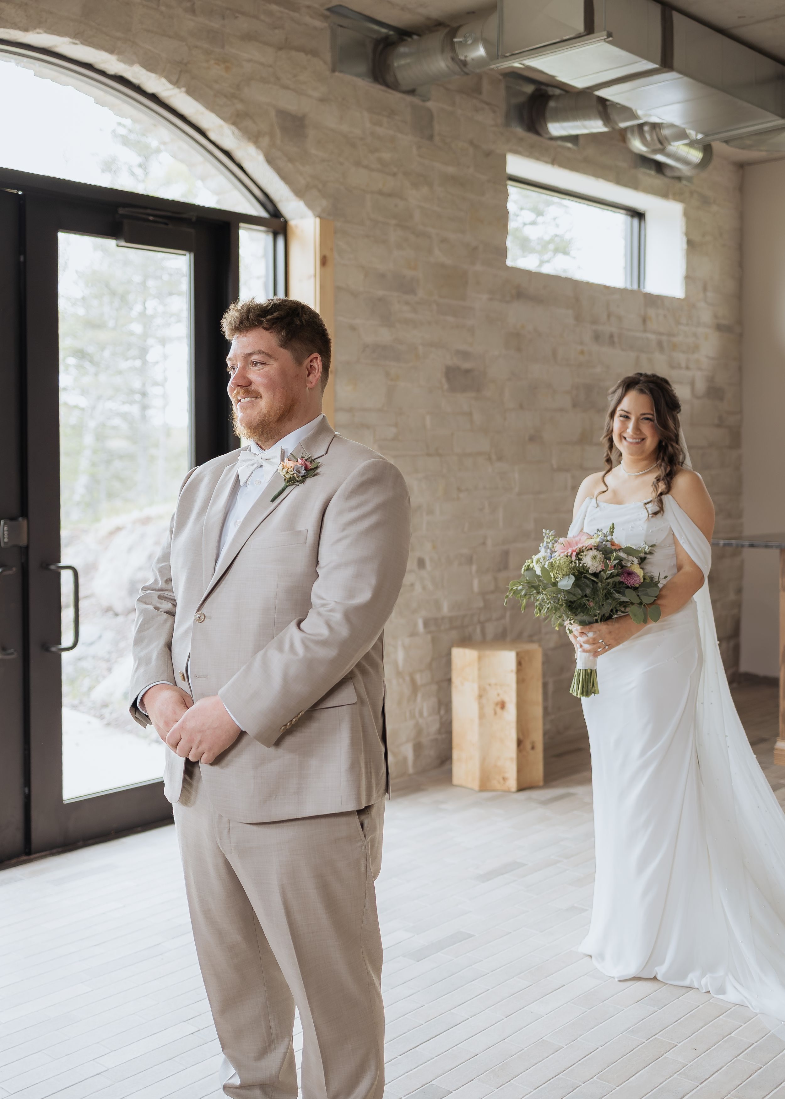 indoor first look between bride and groom rainy spring wedding at Cidery at 51 Acres luxury wedding packages Moncton New Brunswick portraits