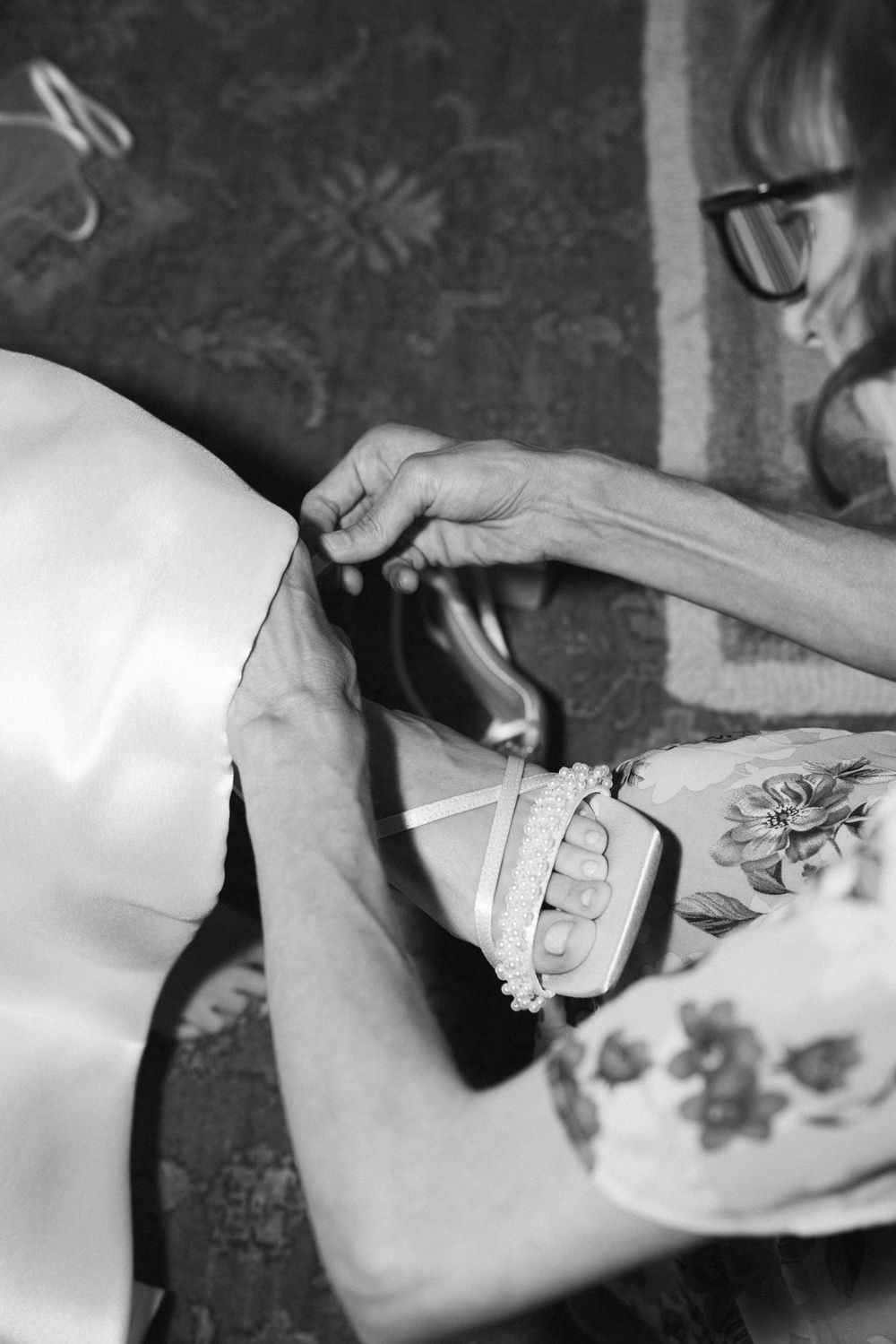 Black and white image of someone applying temporary tattoo art.