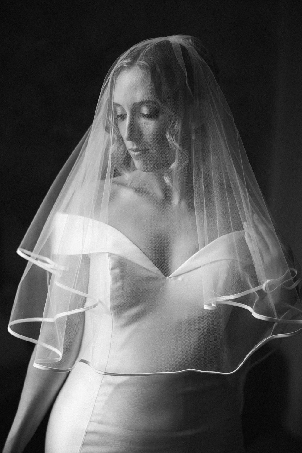 Black and white close-up shots of a bridal veil with delicate ribbon trim details.