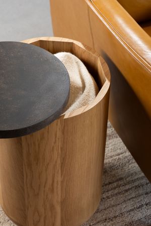 Close-up sequence showing a black iron tool being inserted into smooth wooden joinery detail.