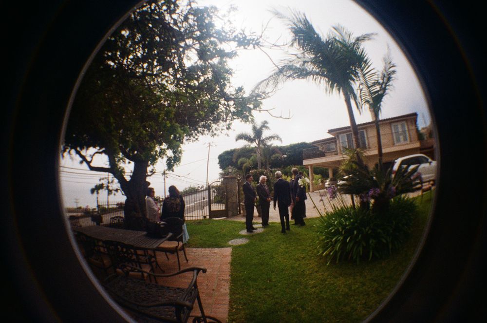 Malibu film photographer using a creative fisheye lens to capture the full scope of an intimate oceanfront ceremony on PCH.