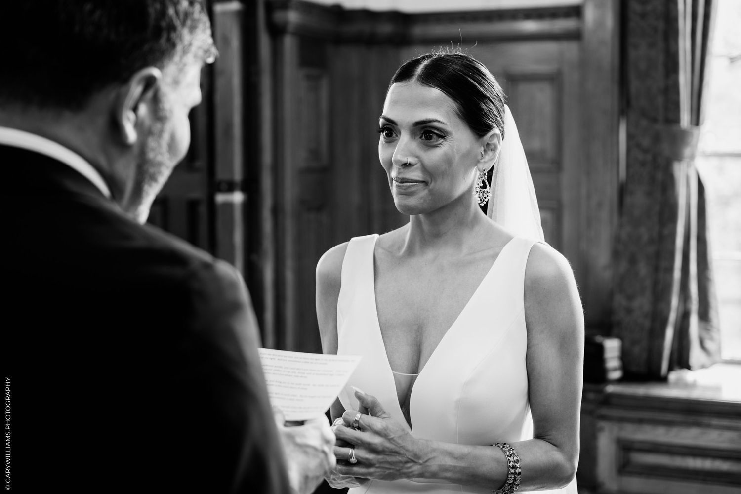 A series of candid black and white wedding photographs showing moments between the bride and guests at a reception.