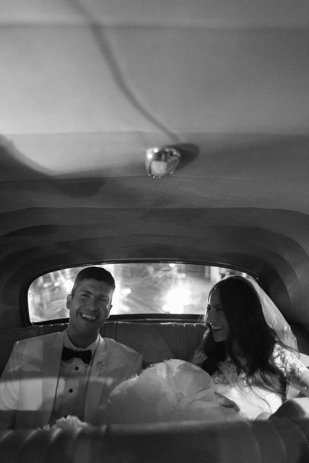 A black and white panoramic sequence shows people sitting inside a car from multiple angles and perspectives.