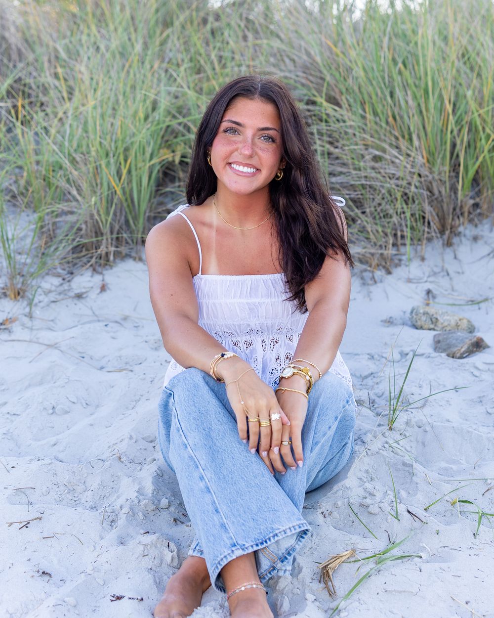 A high school senior poses for her yearbook photos at Wingaersheek Beach in Gloucester, MA in the North Shore with Lisa West Photography.