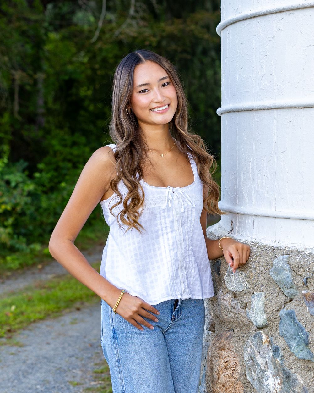 A high school senior poses for her yearbook portraits at Wolbach Farm in Sudbury, MA with Lisa West Photography.