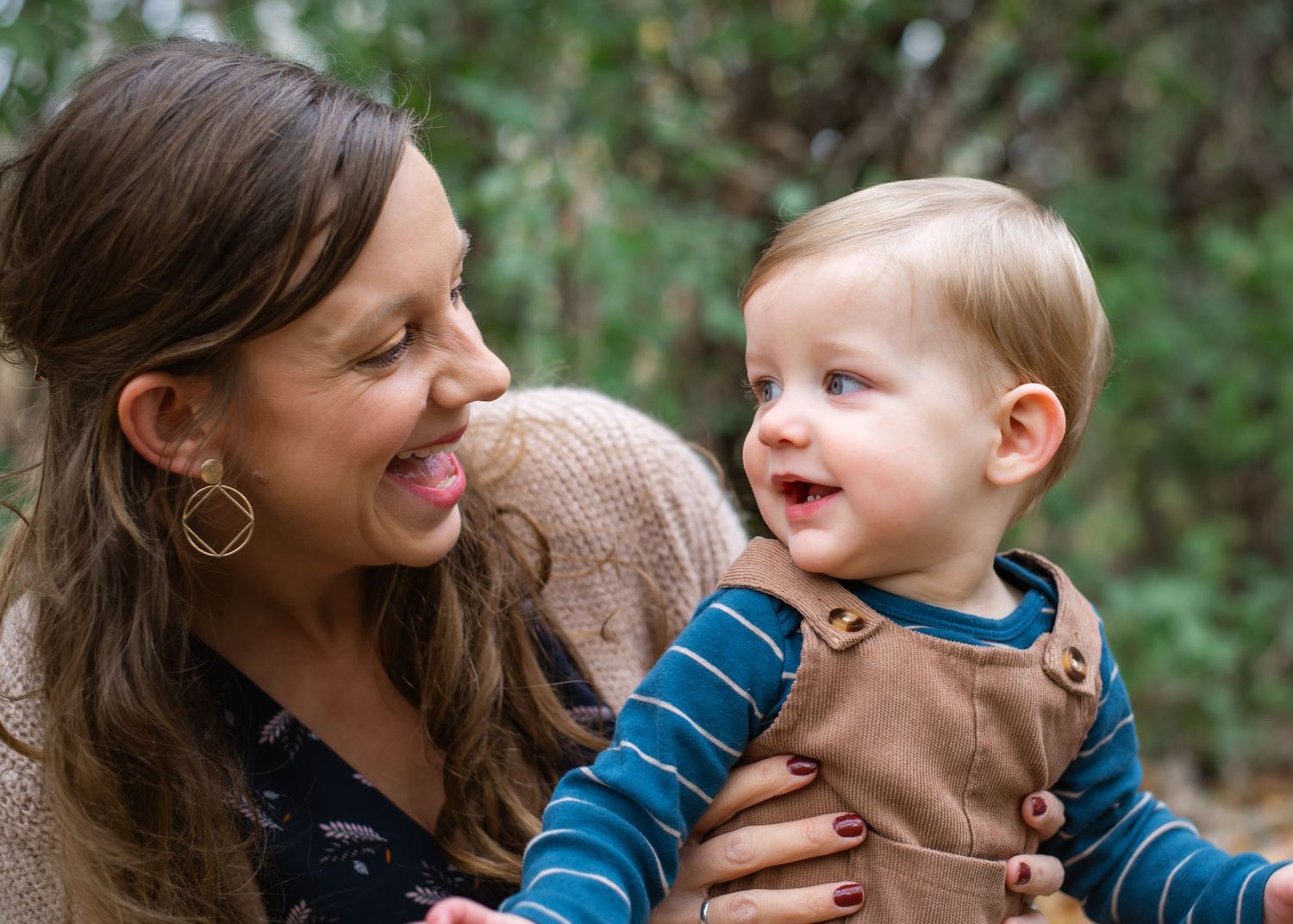 A series of candid moments showing joyful interactions between a parent and baby outdoors in natural light.