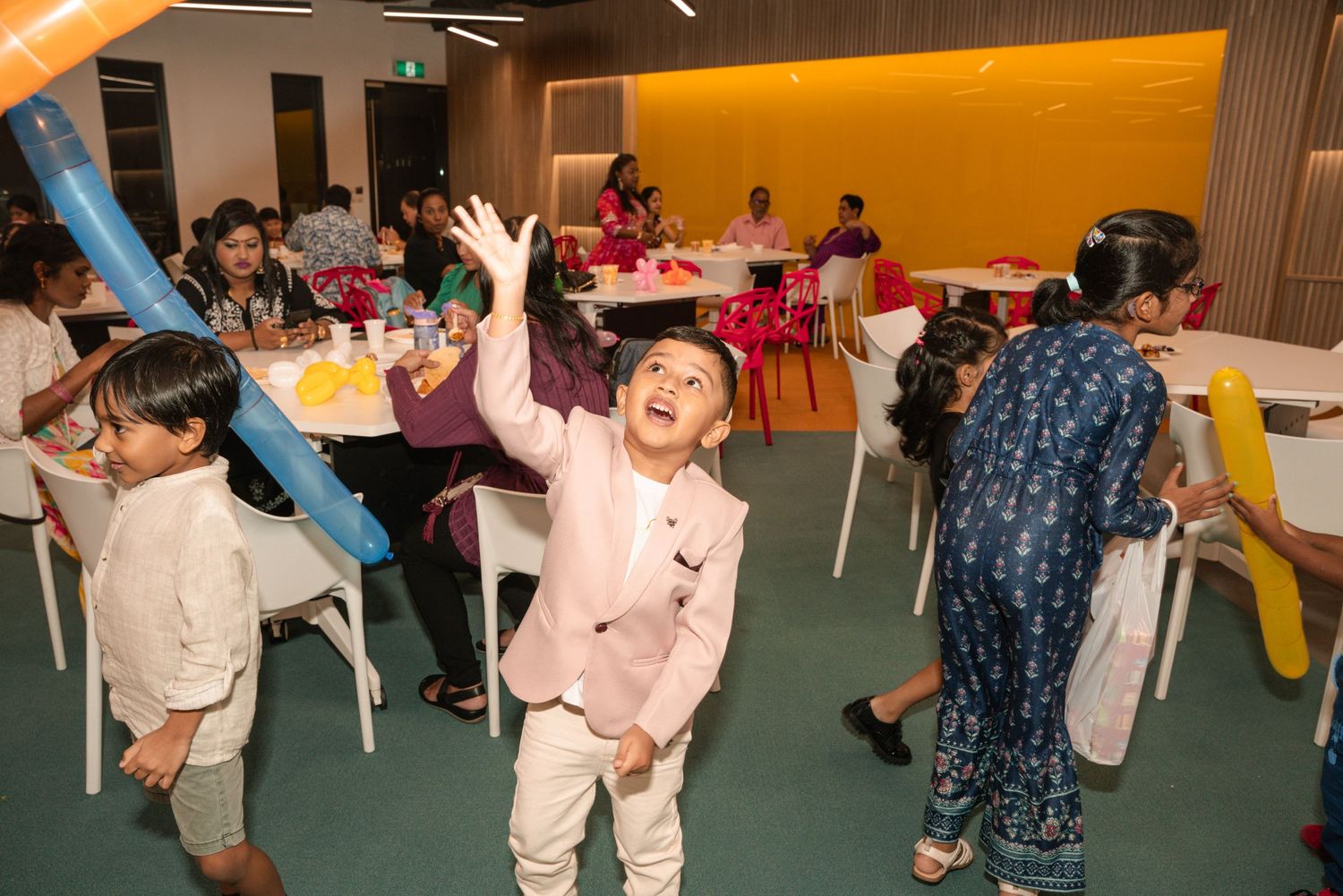 Children celebrating and playing at an indoor birthday party venue.