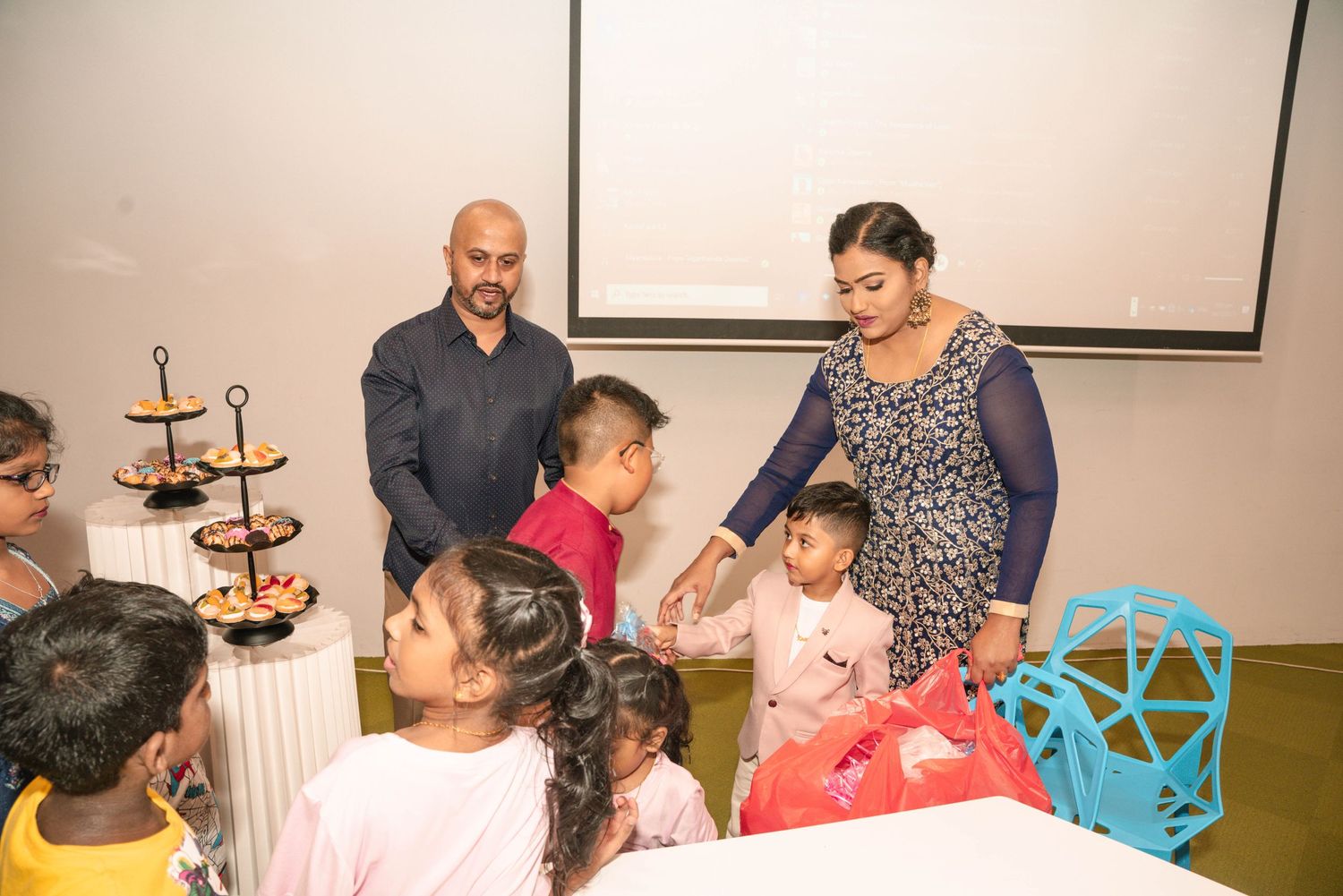 A festive party scene with cupcakes and decorations as guests gather around.