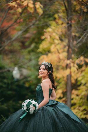 Elegant dark green ballgown with a sweetheart neckline captured in a fall garden setting.
