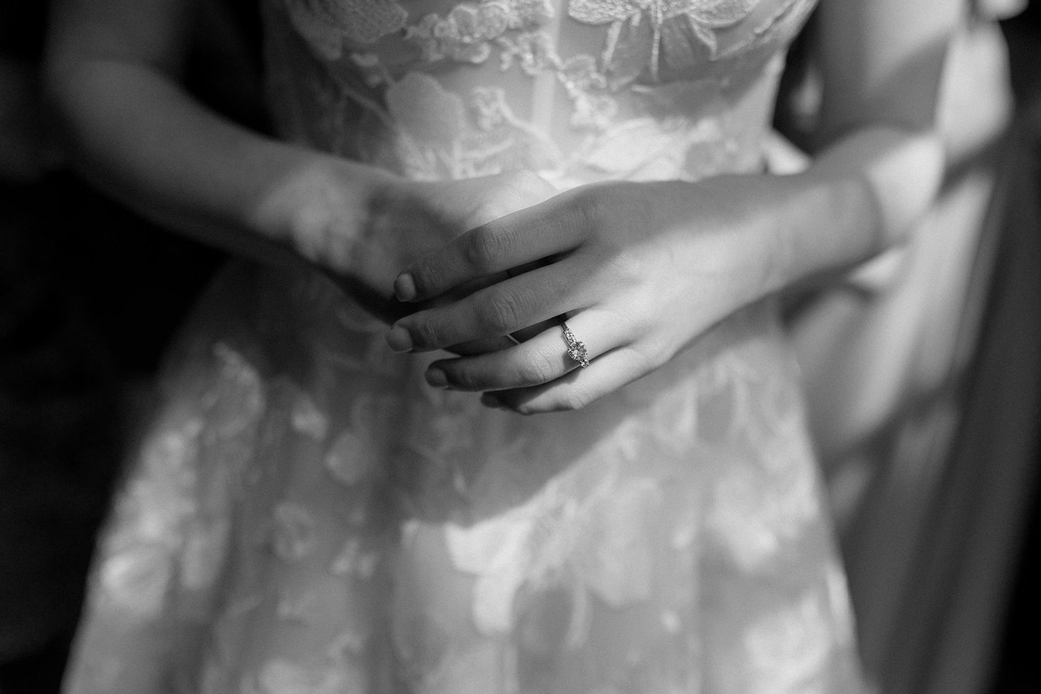 Close-up details of lace wedding dress bodice in black and white.