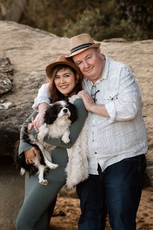 couple hugs with their dog at clifton garden Sydney