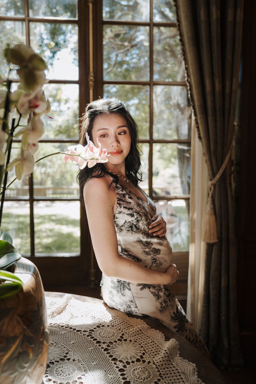 Indoor photoshoot with elegant lace doily and natural window lighting creating a romantic atmosphere.