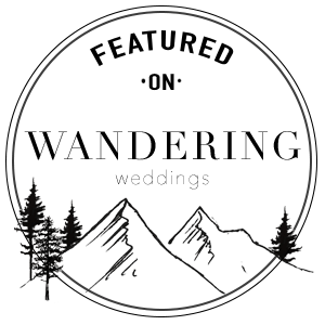 A minimalist circular line drawing features mountain peaks and evergreen trees against a full moon backdrop.