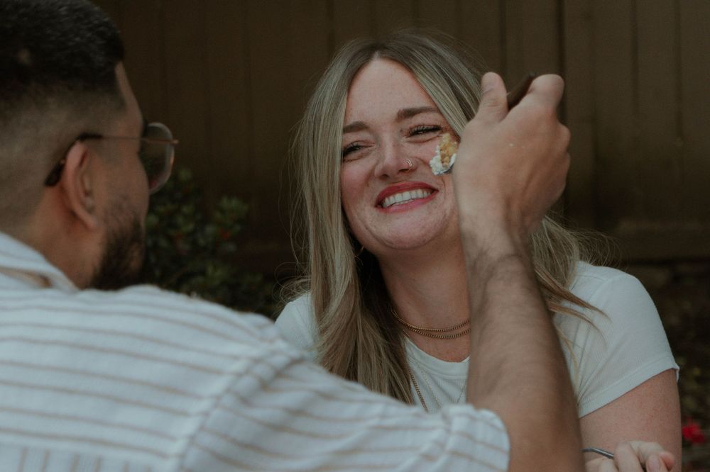 Candid moment of laughter and joy captured during an intimate outdoor photoshoot.