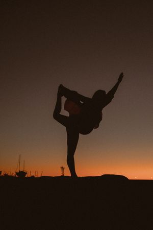 Series of silhouettes performing dance moves against a sunset horizon.