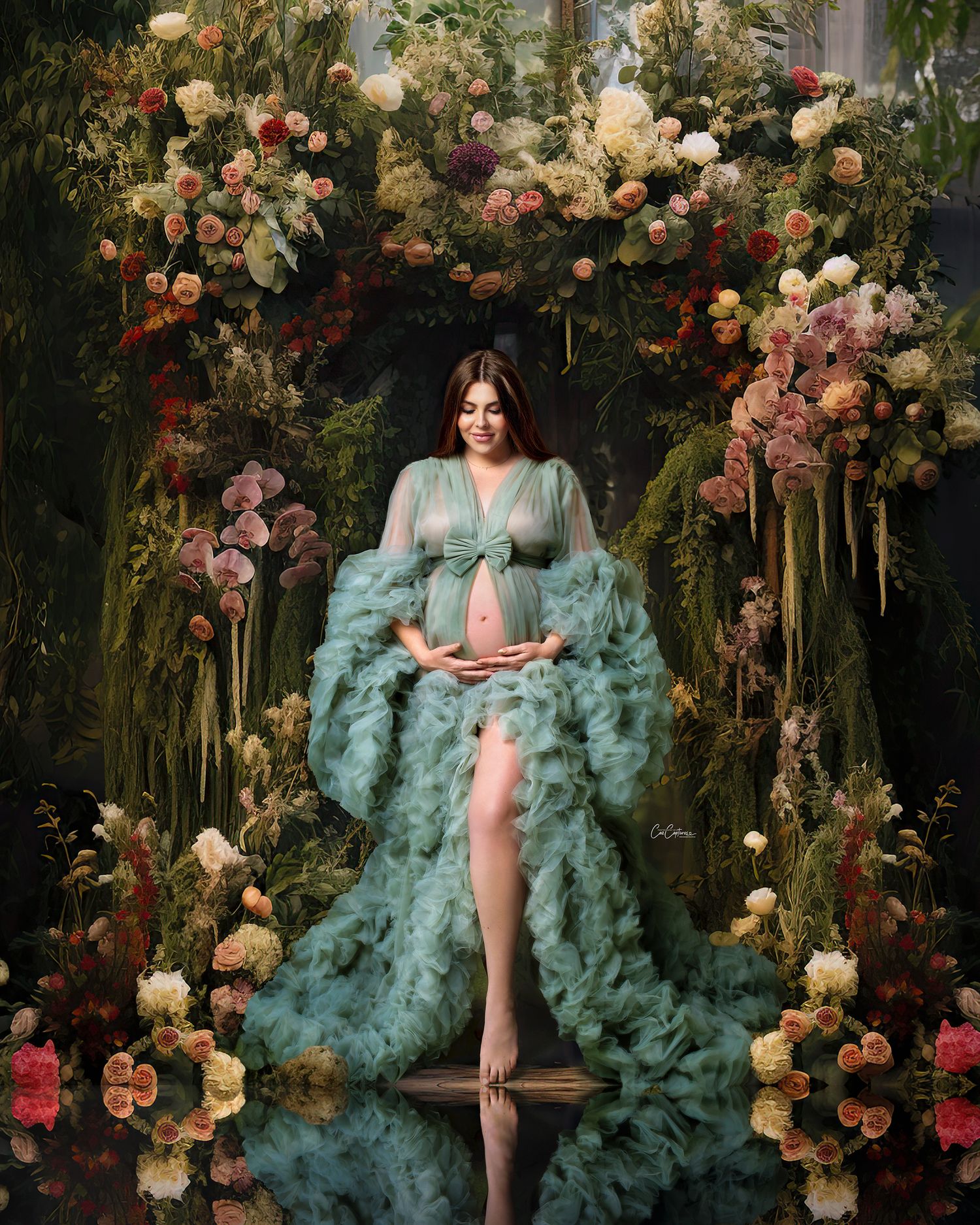Expectant mother looking regal in a flowing sage gown, with a lush green, ethereal digital forest background.