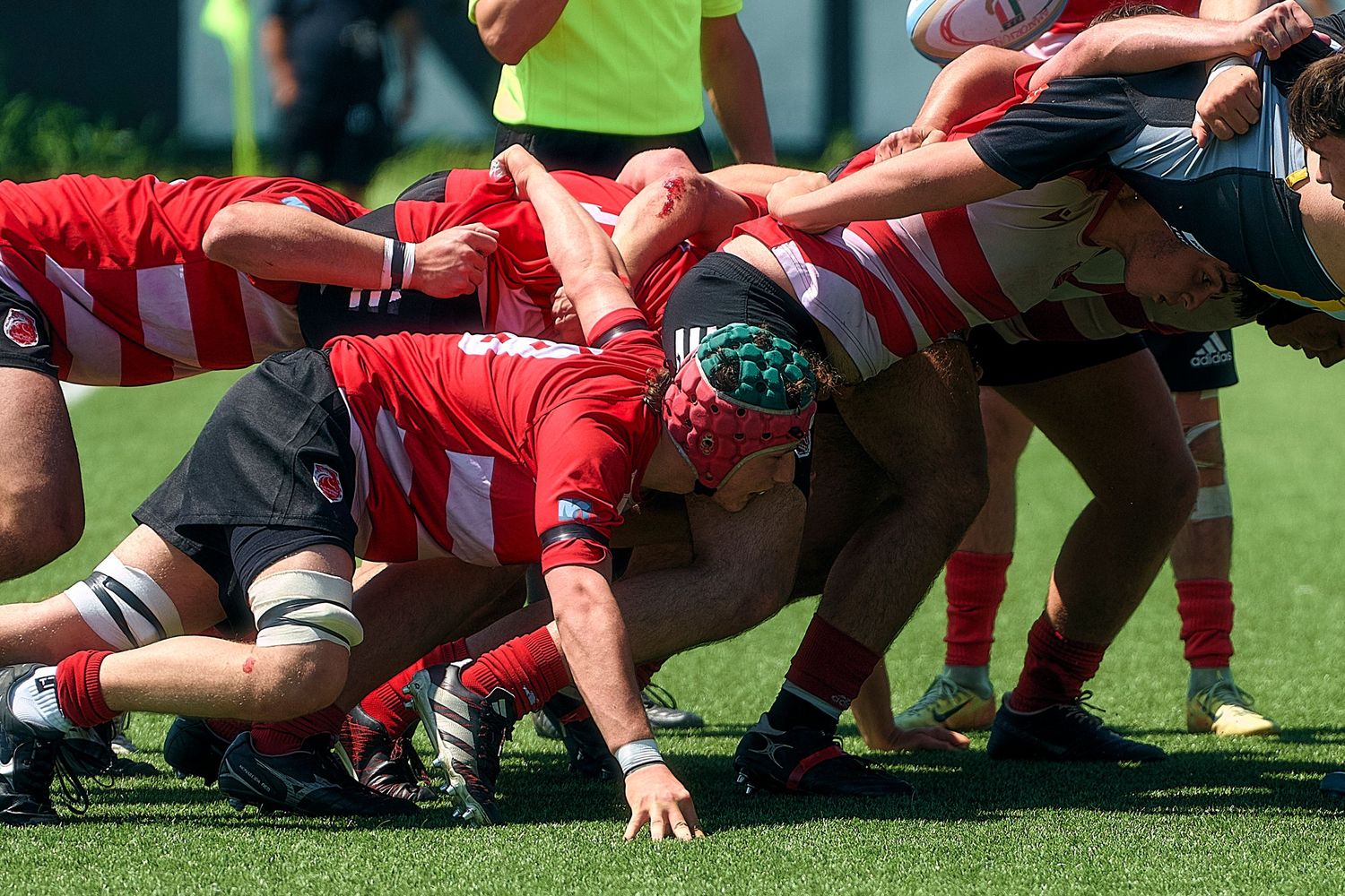 Action shot of amateur football players competing intensely on the field in Milan.