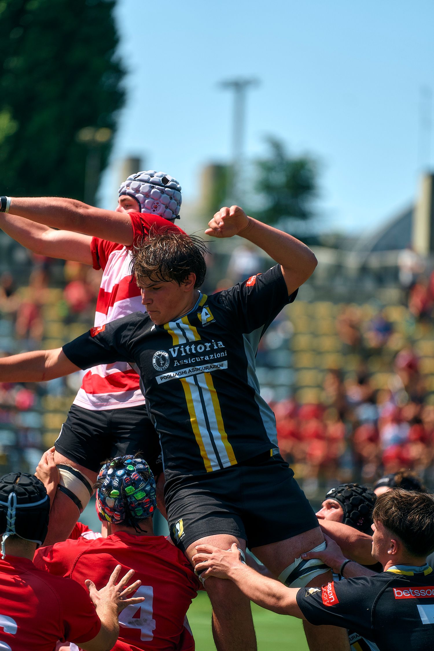 male rugby player jumping for a shot during an amateur league game.