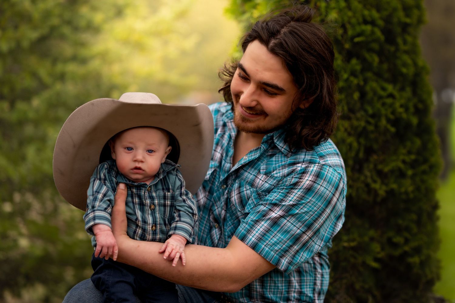 Mother and baby in western wear during outdoor family photo shoot.