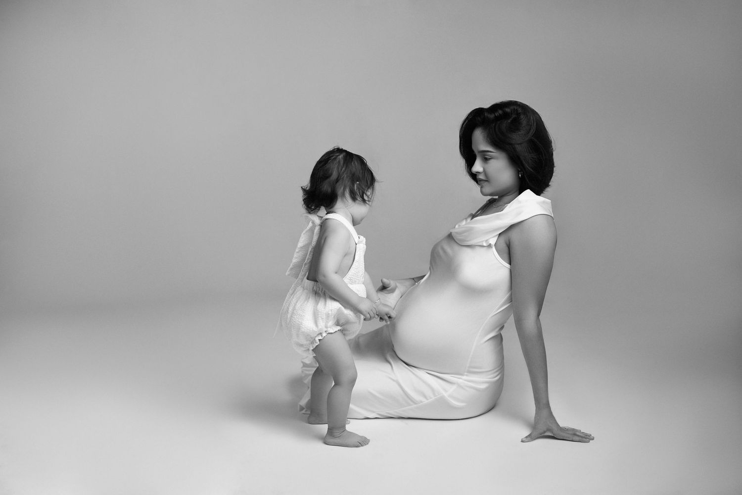 Artistic black and white portraits showing elegant poses and expressions in studio lighting.