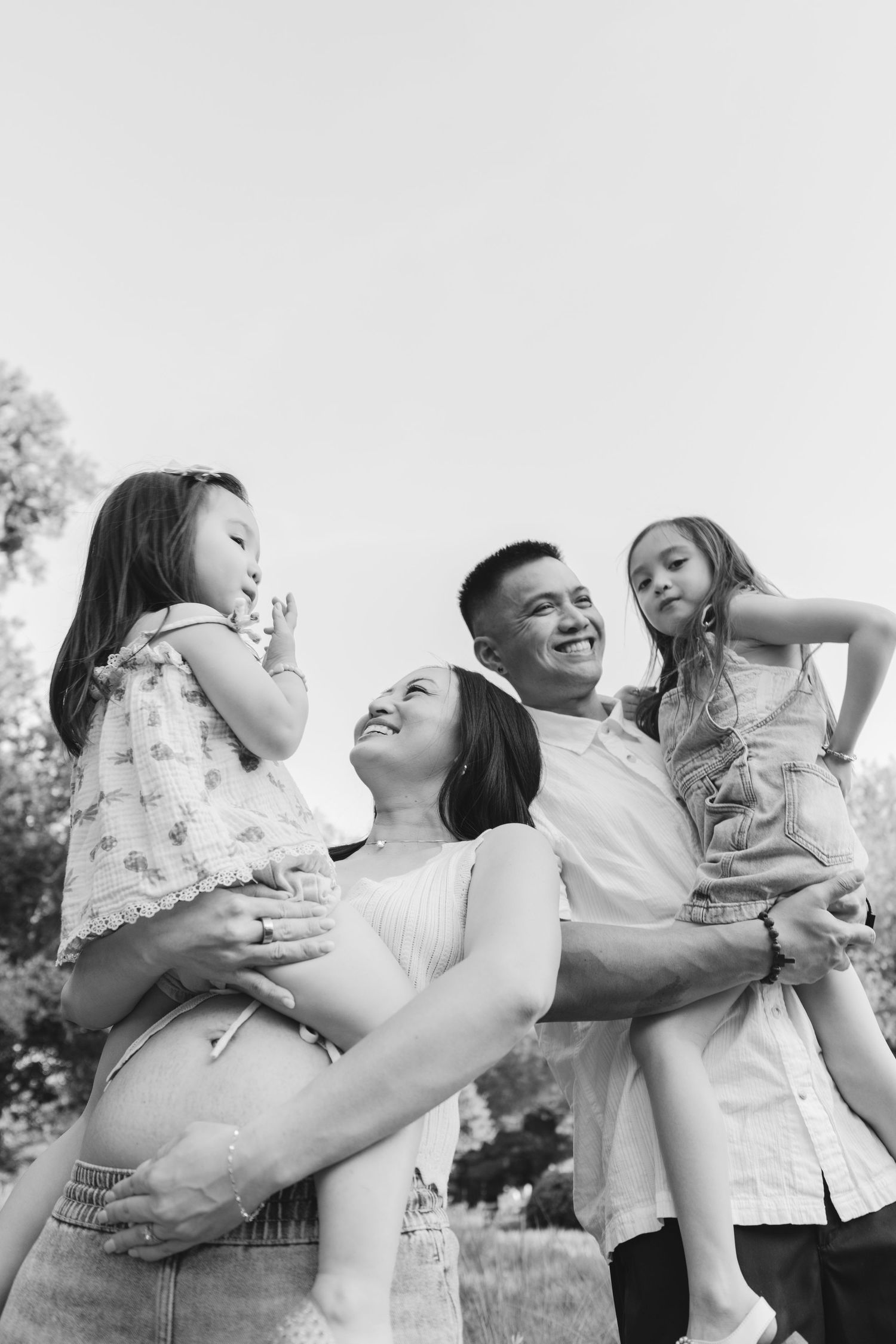 black and white image of happy family with two daughters
