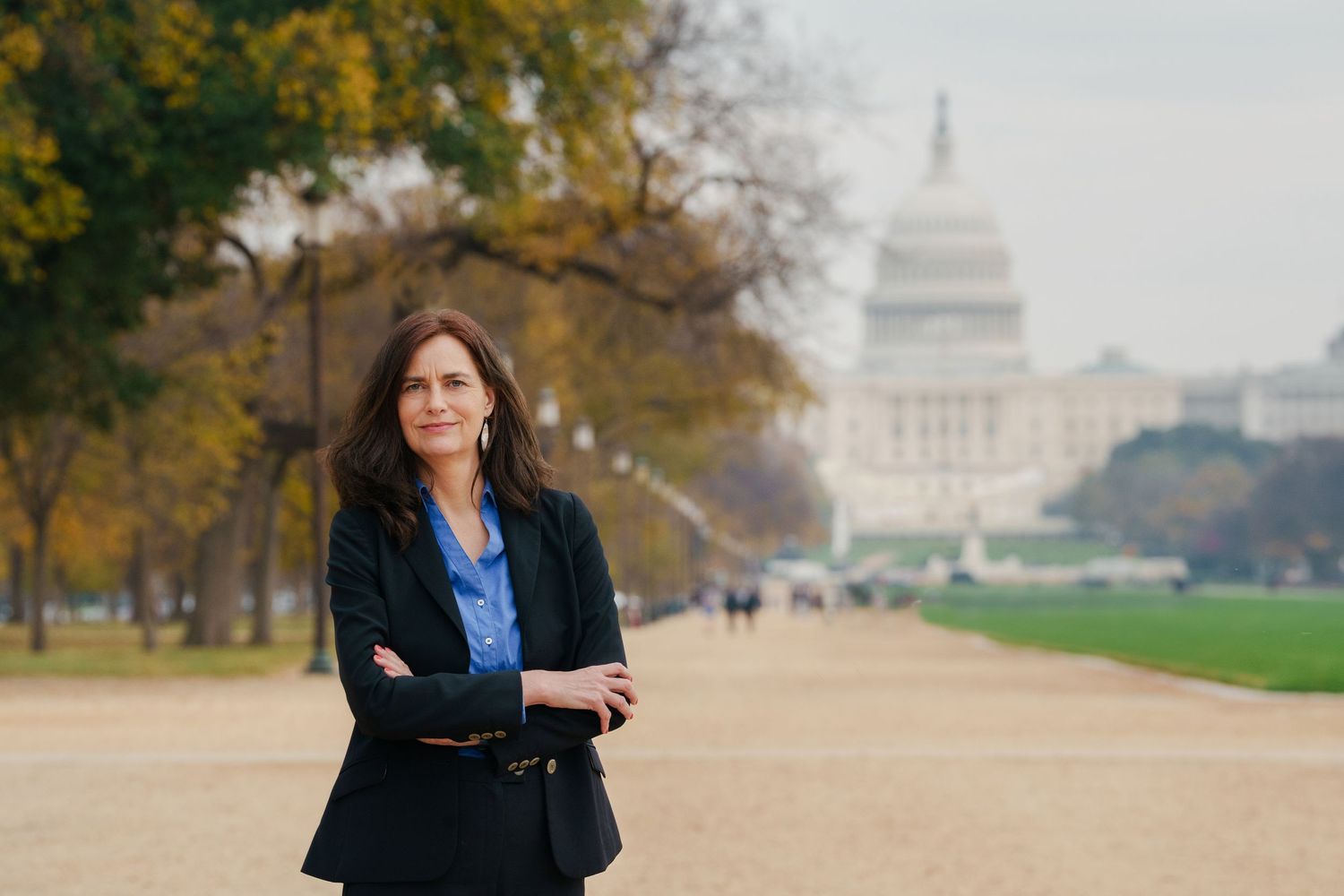 Alexandra Geese, MEP, in business attire stands on the National Mall with the U.S. Capitol building visible in the background.