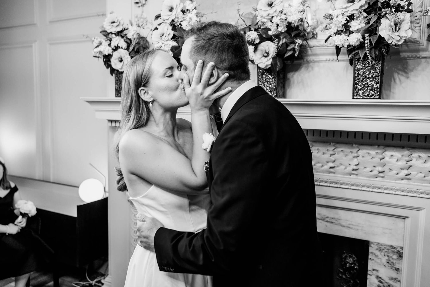 Black and white wedding photo collage showing five romantic kissing moments during a celebration.