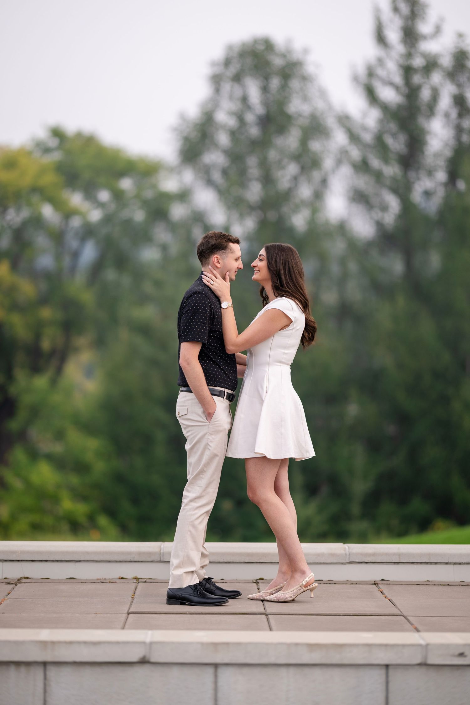 Romantic couple embracing in a garden setting with blooming flowers.