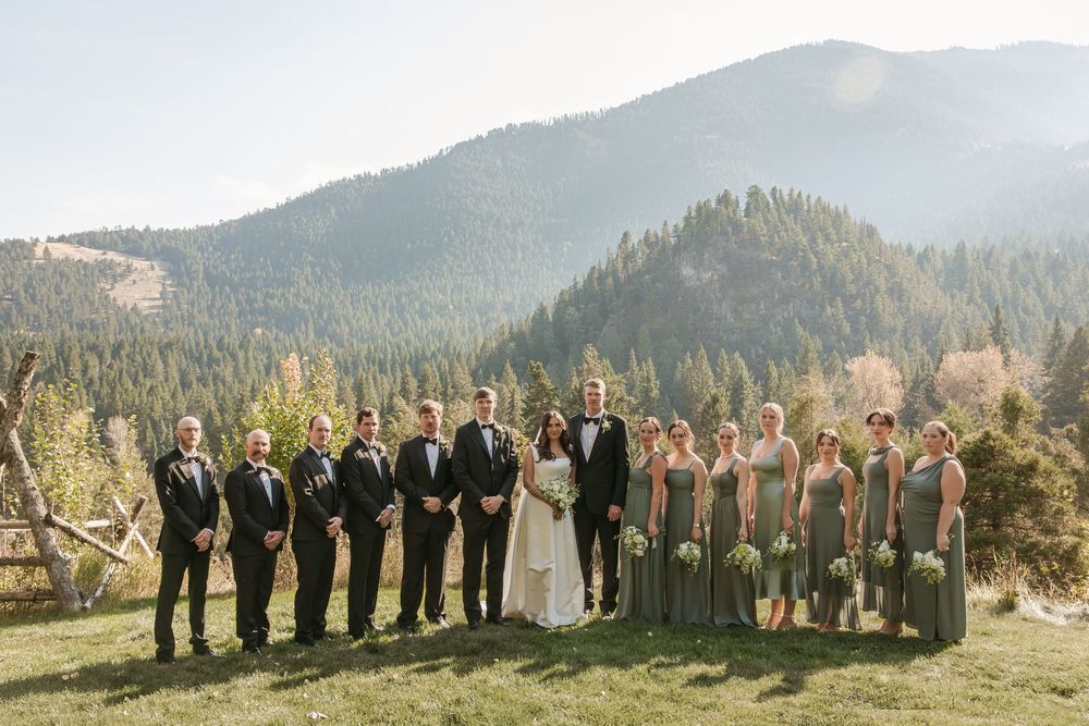 Wedding party poses in panoramic sequence against stunning mountain landscape with evergreen trees in natural light.