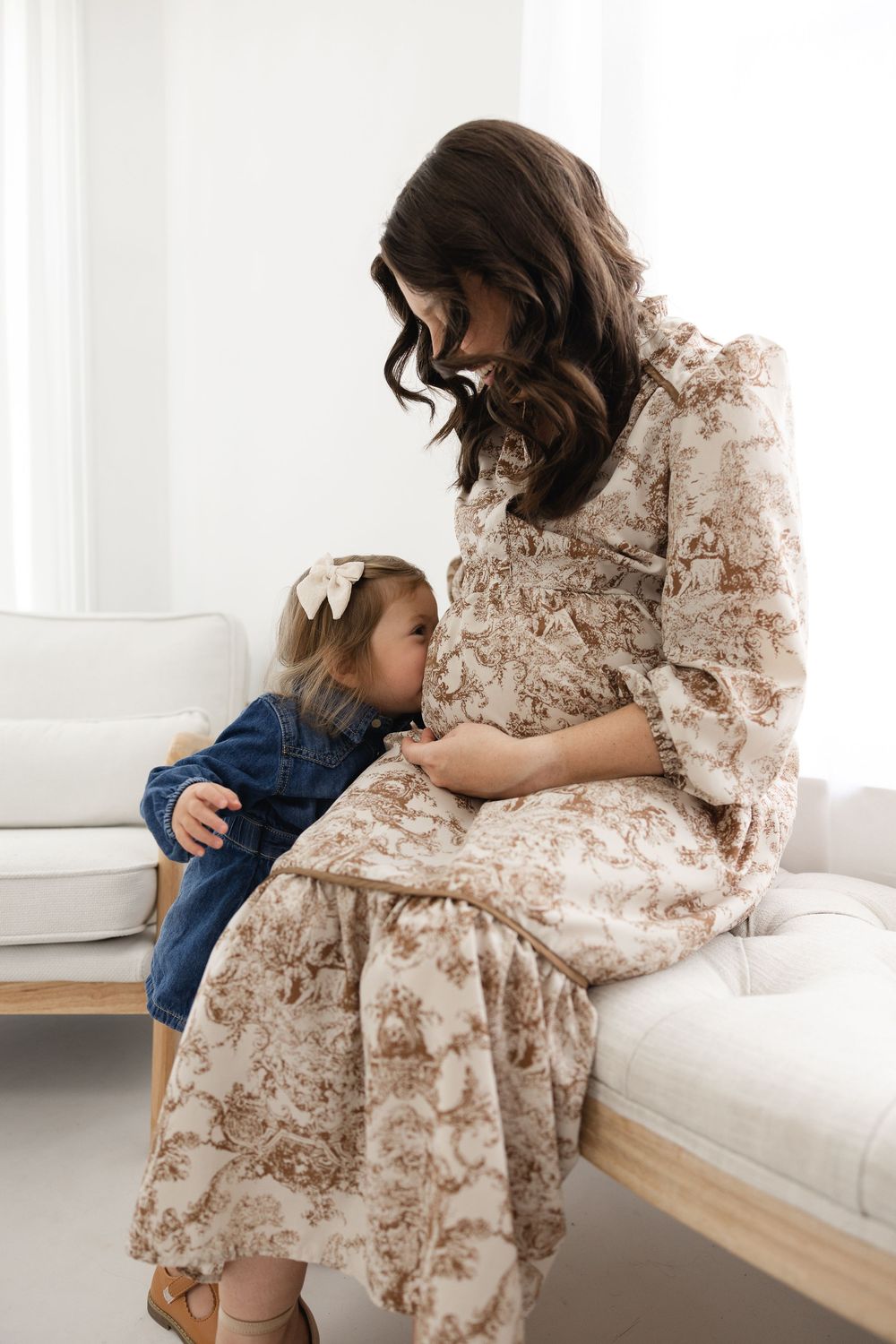 A tender moment captured in a series of photos showing gentle embraces in a bright, minimalist white room setting.