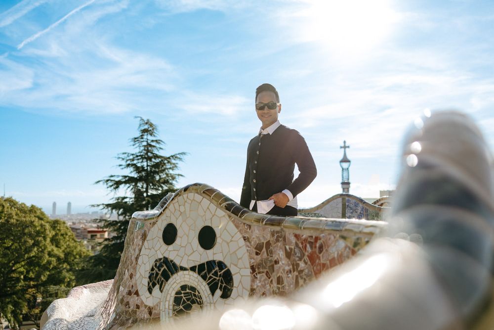 Curved mosaic architecture against bright blue sky in Park Guell.